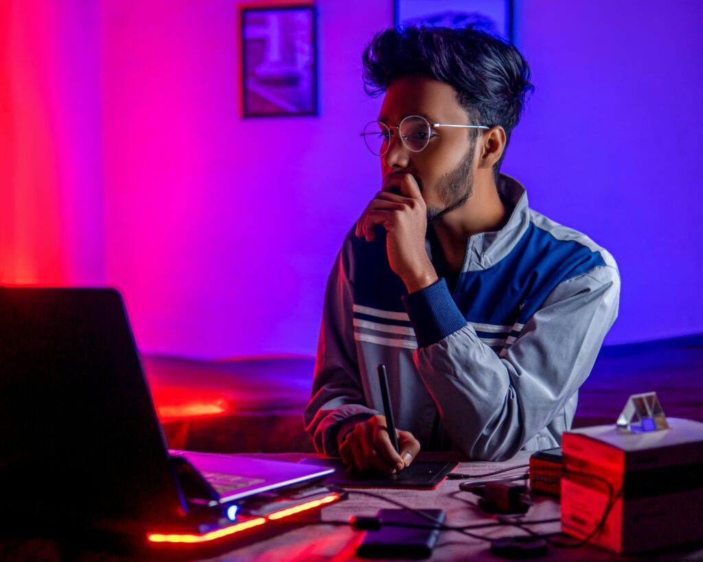 Freelancer stitting at desk looking at laptop