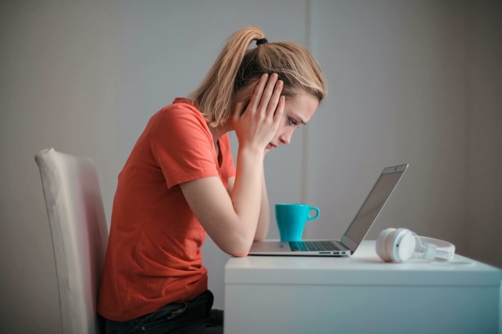 woman looking at laptop unpaid invoice