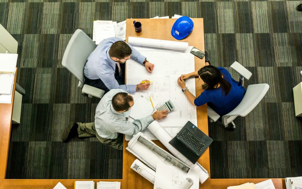 people sitting around table planning project