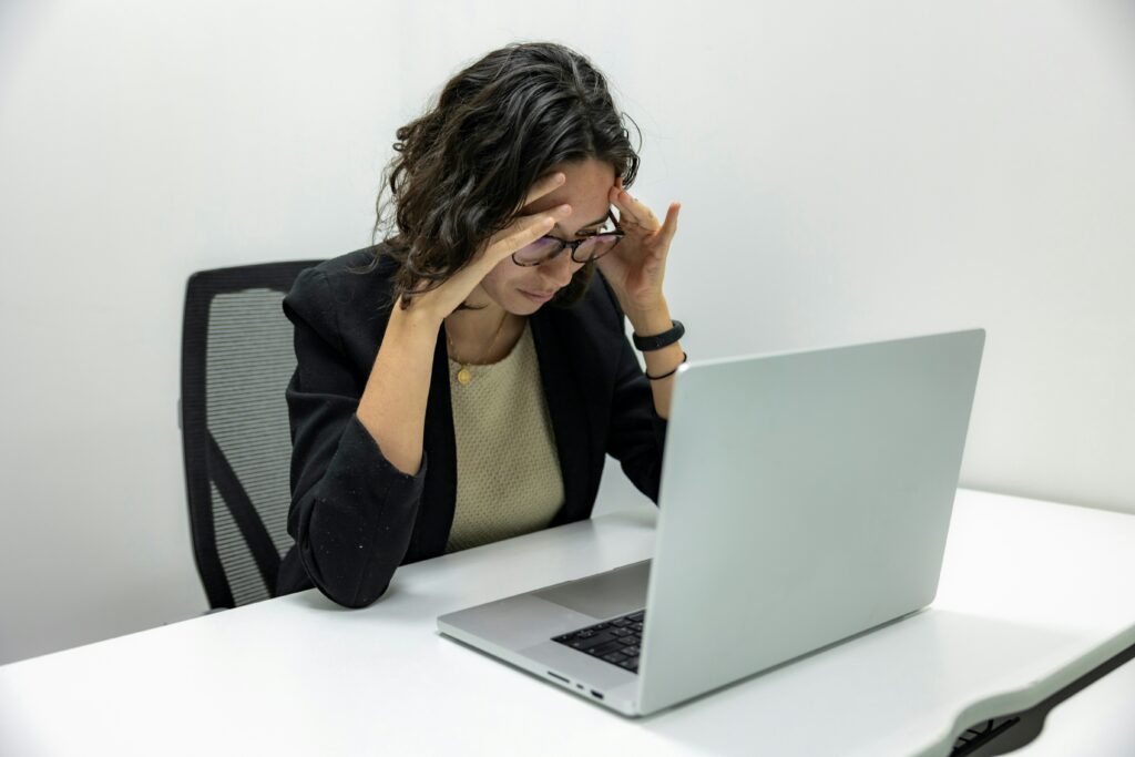 woman looking at laptop concerned